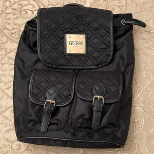 Black quilted backpack with gold hardware